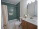Updated bathroom featuring green tile, a shower-tub combination, and modern vanity at 115 Brookwood Ln, Fayetteville, GA 30215