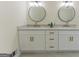 Bathroom featuring a double sink vanity with framed mirrors, modern lighting, and gold hardware at 115 Brookwood Ln, Fayetteville, GA 30215