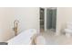 Elegant bathroom featuring a standalone tub, shower, and access to the main bedroom at 115 Brookwood Ln, Fayetteville, GA 30215