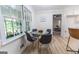 Bright dining area with backyard views, a glass table, seating, and light wood flooring at 115 Brookwood Ln, Fayetteville, GA 30215