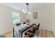 Elegant dining room with modern lighting, minimalist decor, and a view of the outdoors at 115 Brookwood Ln, Fayetteville, GA 30215