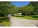 Long driveway leading to a secluded home surrounded by lush greenery and mature trees, providing privacy at 115 Brookwood Ln, Fayetteville, GA 30215