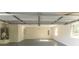 Spacious and bright garage featuring concrete floors, a utility sink, and a water heater at 115 Brookwood Ln, Fayetteville, GA 30215