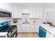 Well-equipped kitchen with ample counter space, stainless steel appliances, and sleek white cabinetry at 115 Brookwood Ln, Fayetteville, GA 30215