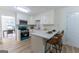 Bright kitchen with quartz countertops, white cabinets, and stainless steel appliances, perfect for cooking at 115 Brookwood Ln, Fayetteville, GA 30215