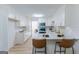 Modern kitchen with white cabinets, stainless steel appliances, and a breakfast bar with seating at 115 Brookwood Ln, Fayetteville, GA 30215