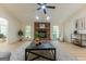 Cozy living room with a brick fireplace, light wood floors, and an open layout at 115 Brookwood Ln, Fayetteville, GA 30215