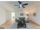 Open living room featuring light wood flooring, gray sofa, a dark coffee table, and modern decor at 115 Brookwood Ln, Fayetteville, GA 30215