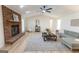 Spacious living room with a brick fireplace, vaulted ceiling, ceiling fan, and lots of natural light at 115 Brookwood Ln, Fayetteville, GA 30215