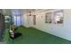 Enclosed patio with white walls, artificial turf flooring, and ceiling fan at 115 Brookwood Ln, Fayetteville, GA 30215