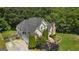 Stunning aerial view of a brick home with lush landscaping, mature trees, and a driveway leading to a garage at 1360 Mount Mckinley Dr, Grayson, GA 30017