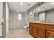 This bathroom features a glass enclosed shower with tiled walls, granite counters and wood cabinets at 1360 Mount Mckinley Dr, Grayson, GA 30017