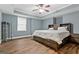 Spacious bedroom features a large bed with built-in storage and a tray ceiling with ceiling fan at 1360 Mount Mckinley Dr, Grayson, GA 30017