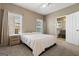 Bright bedroom features a bed, two windows letting in natural light, and an ensuite bathroom at 1360 Mount Mckinley Dr, Grayson, GA 30017