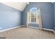 Bedroom showcasing a high ceiling, light blue walls, plush carpet and a window with great outdoor views at 1360 Mount Mckinley Dr, Grayson, GA 30017
