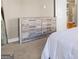 Bedroom featuring a white dresser against a neutral wall, carpet floors, and access to the bathroom at 1360 Mount Mckinley Dr, Grayson, GA 30017