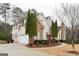 Brick home with three gables featuring manicured lawn, mature trees and decorative stone accents at 1360 Mount Mckinley Dr, Grayson, GA 30017