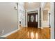 Welcoming foyer with hardwood floors, ornate trim and a decorative front door at 1360 Mount Mckinley Dr, Grayson, GA 30017
