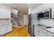 Kitchen with white cabinets, stainless steel appliances, granite countertops and hardwood floors at 1360 Mount Mckinley Dr, Grayson, GA 30017