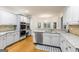 Bright kitchen with white cabinets, granite countertops, stainless appliances and hardwood floors at 1360 Mount Mckinley Dr, Grayson, GA 30017