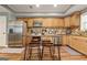 Well-lit kitchen with stainless steel appliances, wood cabinets, and a convenient island with barstool seating at 1360 Mount Mckinley Dr, Grayson, GA 30017