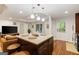 The kitchen island features granite counters, wood cabinets, and hanging pendant lights above at 1360 Mount Mckinley Dr, Grayson, GA 30017