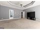 Expansive living room featuring a tray ceiling, carpet, and ample natural light at 1360 Mount Mckinley Dr, Grayson, GA 30017