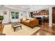 Open-concept living room and kitchen area with wood floors, natural light, and kitchen island at 1360 Mount Mckinley Dr, Grayson, GA 30017
