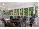 This screened-in porch has wood look tile flooring with large windows bringing the outside in at 1360 Mount Mckinley Dr, Grayson, GA 30017