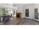 Sunroom features wood look tile flooring, wooden fireplace and lots of natural light at 1360 Mount Mckinley Dr, Grayson, GA 30017