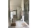 Neutral toned bathroom featuring a glass shower, tile floors, and convenient towel rack at 160 Elysian Dr, Fayetteville, GA 30214
