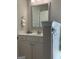 The bathroom has a white vanity and silver-framed mirror, accented with neutral wall color and simple fixtures at 160 Elysian Dr, Fayetteville, GA 30214