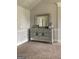 Bedroom featuring a large decorative dresser, mirror, and overhead lighting at 160 Elysian Dr, Fayetteville, GA 30214