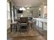 The dining area boasts a charming table with bench seating, seamlessly connected to the living room and kitchen at 160 Elysian Dr, Fayetteville, GA 30214