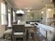 Open-concept dining area features a stylish table with bench seating and views to the living room and kitchen at 160 Elysian Dr, Fayetteville, GA 30214