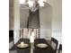 Dining room with staircase view, features decorative place settings and elegant chandelier at 160 Elysian Dr, Fayetteville, GA 30214