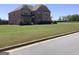 Well-maintained two-story brick home with a lush, expansive front lawn under a clear blue sky at 160 Elysian Dr, Fayetteville, GA 30214