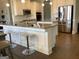 Spacious kitchen with white cabinets, stainless steel appliances, granite counters, and bar seating at the island at 160 Elysian Dr, Fayetteville, GA 30214