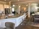 Bright kitchen offers an island with bar seating and granite counters, connecting to dining and living areas at 160 Elysian Dr, Fayetteville, GA 30214
