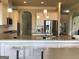 Gourmet kitchen with white cabinets, stainless appliances, granite countertops, and a central island with barstools at 160 Elysian Dr, Fayetteville, GA 30214