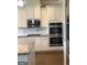 Well-equipped kitchen featuring stainless appliances, white cabinetry, granite countertops, and double ovens at 160 Elysian Dr, Fayetteville, GA 30214