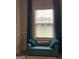 Bright window featuring teal curtains and a matching cushioned bench seat and plush pillows at 160 Elysian Dr, Fayetteville, GA 30214