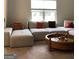 Bright living room with a modular sectional sofa and a round wooden coffee table at 160 Elysian Dr, Fayetteville, GA 30214