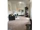 Cozy living room featuring a comfortable gray couch, treadmill, fireplace, and flat screen television at 160 Elysian Dr, Fayetteville, GA 30214