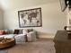 A neutral-toned living room showcases a large decorative world map and plush sectional sofa at 160 Elysian Dr, Fayetteville, GA 30214