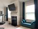 Bright living room with a fireplace, flat screen tv, and a cushioned bench by a bright window at 160 Elysian Dr, Fayetteville, GA 30214
