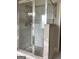 A tiled glass shower features neutral tiles, stone accents, and built-in shelves at 160 Elysian Dr, Fayetteville, GA 30214