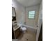 Bathroom featuring a vanity sink and a tub/shower combo with window view at 125 Rosenwald Cir, Stockbridge, GA 30281