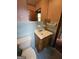 Bathroom featuring a toilet, vanity with sink, and blue tiled walls at 125 Rosenwald Cir, Stockbridge, GA 30281