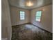 Bedroom with two windows and neutral walls at 125 Rosenwald Cir, Stockbridge, GA 30281
